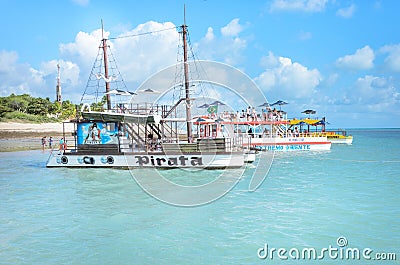 Pirate-themed boat that transports tourists on beautiful beach with blue water on a sunny day Editorial Stock Photo