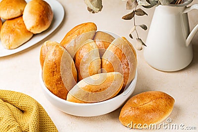 Pirozhki, piroshki. Homemade baked yeast leavened boat shaped buns Stock Photo