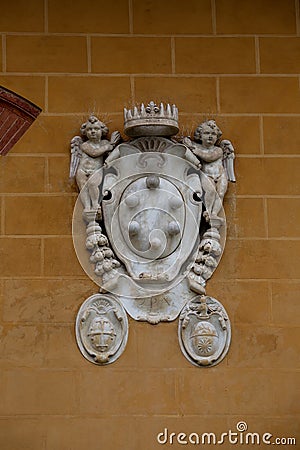 Medici family embleme on a facade of Palazzo dell'Opera located on Piazza dei Miracoli, Pisa, Italy Editorial Stock Photo