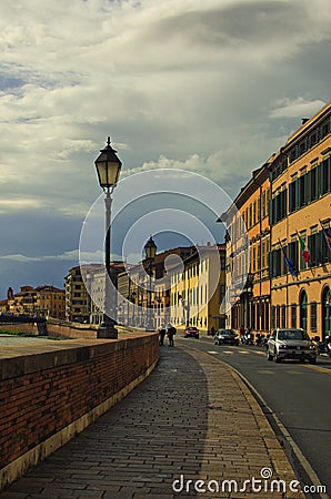 Scenic landscape view of medieval Italian architecture in Pisa. Colorful vintage buildings along embankment of Arno river Editorial Stock Photo