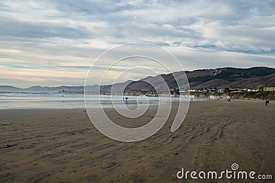 Pismo State Beach, California. Seashore, mountains, Pacific ocean, and cloudy sky on background Stock Photo