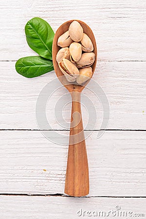 Pistachios nuts on a white wooden background. Healthy snacks. Top view. Stock Photo