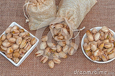 Pistachios in a sack and ceramic bowl Stock Photo