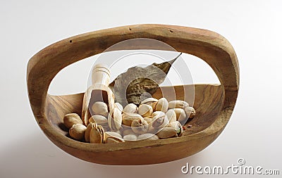 Pistachios in a wooden bowl. Stock Photo