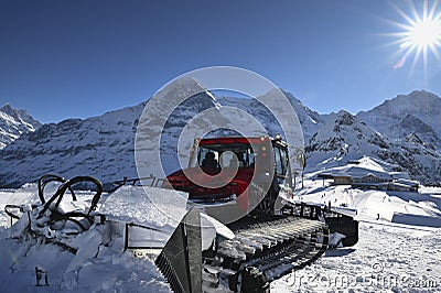 Pistenbully in front of Eiger, Moench and Jungfrau in Bernese Oberland, Switzerland Editorial Stock Photo