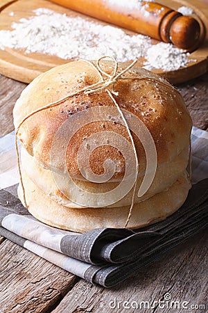 Pita bread closeup on a background of a rolling pin and flour Stock Photo