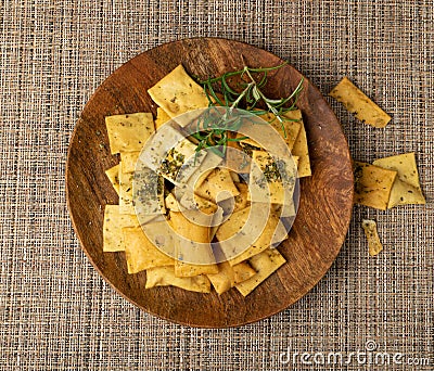 Pita Chips Pile on Wood Plate, Small Wheat Tortillas, Crunchy Flat Bread, Spicy Mediterranean Wheat Snack Stock Photo