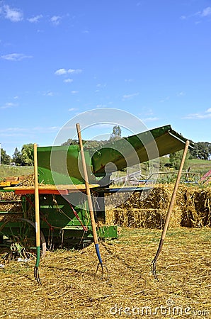 Pitch forks in front of threshing machine Stock Photo