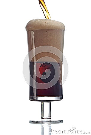 Frothy dark beer in glass in white studio Stock Photo