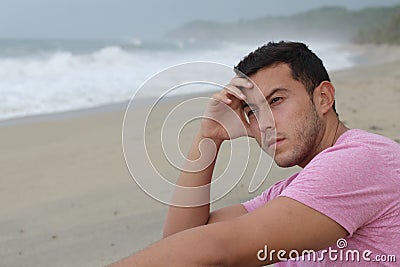 Pitiful young man at the beach Stock Photo