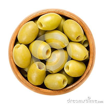 Pitted and marinated green olives in wooden bowl Stock Photo