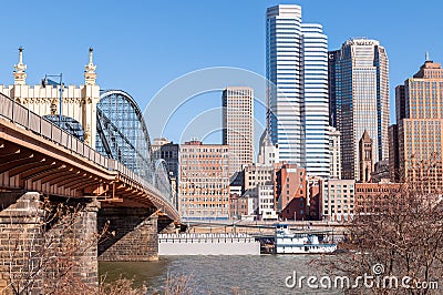 Pittsburgh, Pennsylvania, USA 2-6-21 A tugboat and barge travel on the Monongahela river going under the Stanwix street bridge Editorial Stock Photo