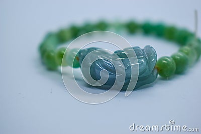 PIXIU on a natural stone bracelet. Jade dragon. bracelets made of natural stones aventurine green. Stock Photo