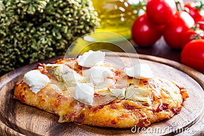 Pizza with artichoke and oregan on wood Stock Photo