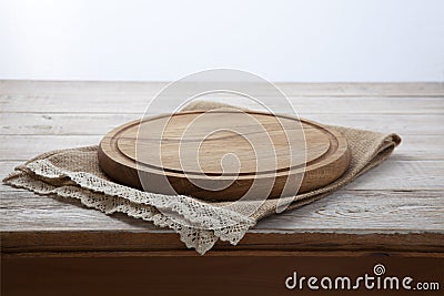 Pizza board, canvas napkin with lace on wooden table. Top view mock up Stock Photo