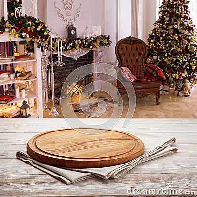 Pizza board, with napkin on wooden table. Top view mockup. Festive sparkling Christmas interiors background Stock Photo