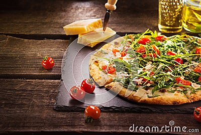 Pizza Caprese with arugula, cheese, yoghurt and cherry tomatoes Stock Photo