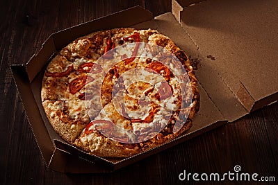 Pizza in the in delivery box on the wood Stock Photo