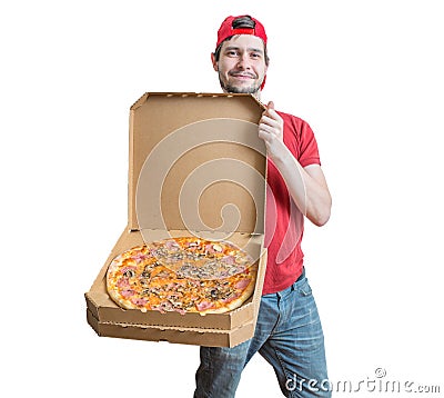 Pizza delivery concept. Young smiling guy is delivering tasty pizza. Stock Photo