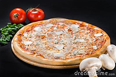 Pizza Four Cheese with bacon, mozzarella, parmesan, feta and Dor Blue cheeses on wooden board on dark background Stock Photo