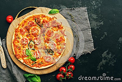 Pizza Margarita with cherry tomatoes, mozzarella and Basil on a cutting Board. Top view, flat lay. Toned photo Stock Photo