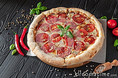 Pizza Margherita on black background, top view. Pizza Margarita with Tomatoes, Basil and Mozzarella Cheese Stock Photo