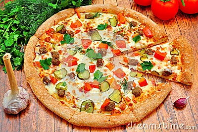 Pizza with meat, cucumbers, tomatoes and greens Stock Photo