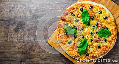 Pizza with Mozzarella cheese, Tomatoes, pepper, olive, Spices and Fresh Basil. Italian pizza. Pizza Margherita or Margarita on woo Stock Photo