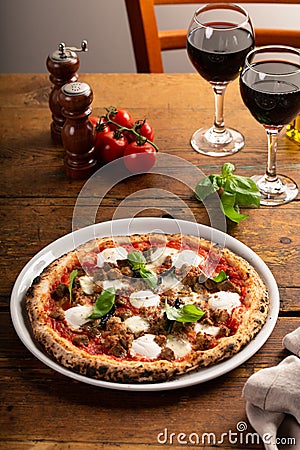 Pizza Napolitana or Naples style with mozzarella, basil and sausage Stock Photo