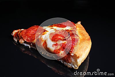 Pizza. Pizza slice on black reflective studio background. Isolated black shiny mirror mirrored background for every concept. Stock Photo