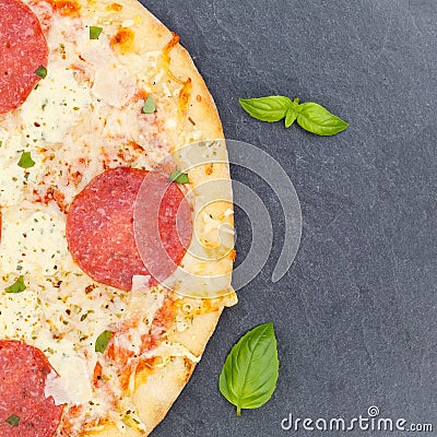 Pizza salami from above copyspace copy space square close up on a slate Stock Photo