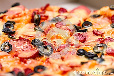 Pizza with salami, cheese and black olives Stock Photo