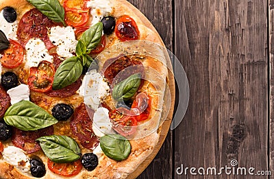 Pizza with salami and mozzarella top view with copy space rustic Stock Photo