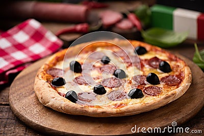 Pizza slice with olives and salami toping Stock Photo