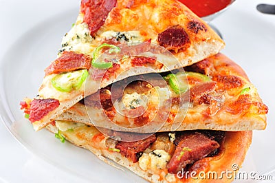 Salami pizza slices on the plate Stock Photo