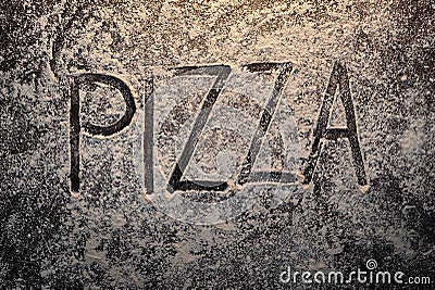 Pizza text on flour top view Stock Photo