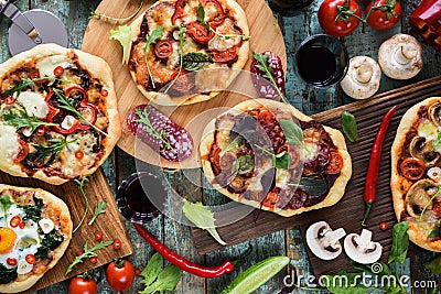 Pizza and wine party. Homemade rustic pizzas and raw ingredients Stock Photo