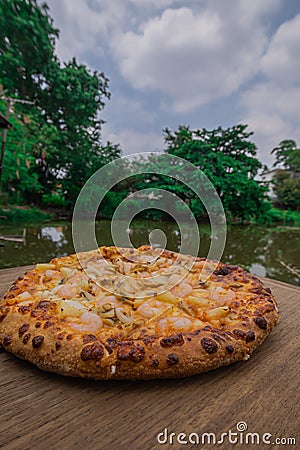 Pizza on wood. Shrimp Pizza. Pizza background image placed on a wooden floor Stock Photo