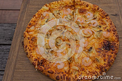 Pizza on wood. Shrimp Pizza. Stock Photo