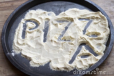 Pizza word written on the flour Stock Photo