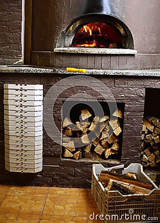 Pizzeria fire stone stove oven and boxes for pizza delivery. Stock Photo