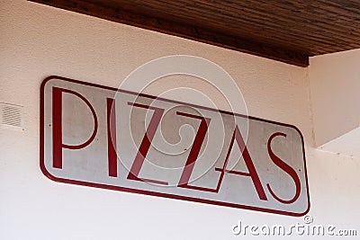Pizzeria pizzas sign words painted on a restaurant shop wall of italian pizza food Stock Photo