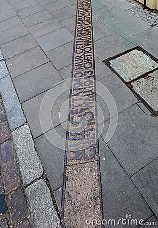The place marked on the pavement where the wall of the Warsaw Ghetto was Editorial Stock Photo