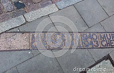 The place marked on the pavement where the wall of the Warsaw Ghetto was Editorial Stock Photo