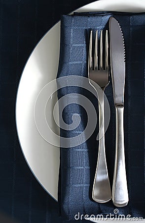 Place setting with blue napkin Stock Photo