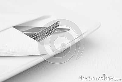 Place setting, white plate with cutlery Stock Photo