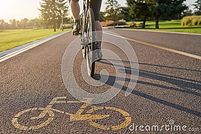 Place to train. Close up of a bicycle sign drawn on asphalt. Professional male cyclist riding a road bike on a cycle Stock Photo