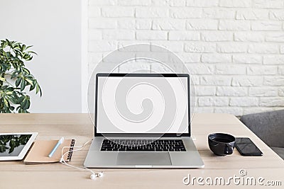 Place of work, home office, laptop computer, notebook, coffee cup, smartphone at desk Stock Photo