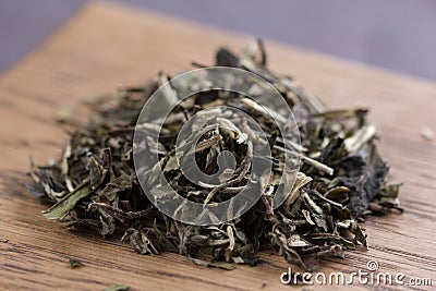 Placer of white tea on a wooden background, macro Stock Photo