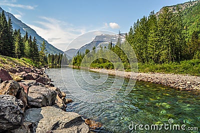 A Mountain River Streams Down From High Above in Glacier National Park Stock Photo